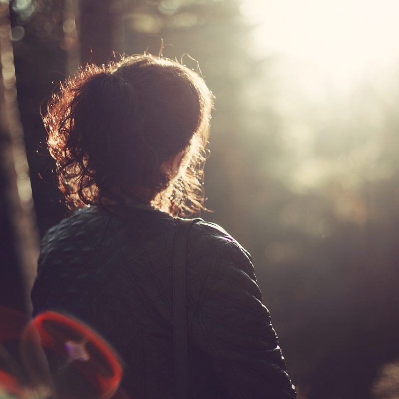 woman sitting in the forrest